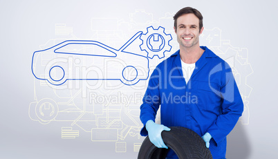 Composite image of confident mechanic holding tire