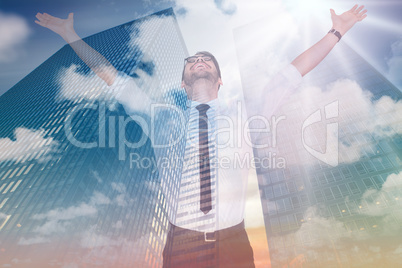 Composite image of cheering businessman with his arms raised up