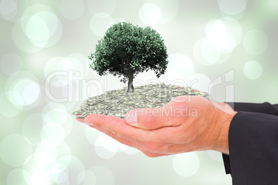 Composite image of businessman holding his hands out