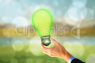 Composite image of businessman holding hand out in presentation