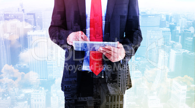 Composite image of businessman scrolling on his digital tablet