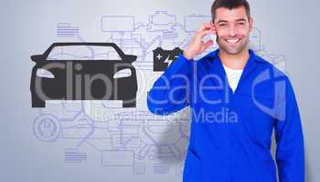 Composite image of portrait of smiling male mechanic using mobil