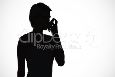 Composite image of blonde woman taking her inhaler