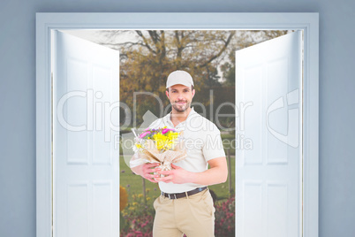 Composite image of delivery man holding bouquet