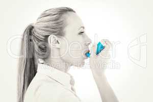 Pretty blonde using an asthma inhaler