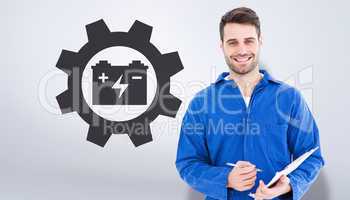 Composite image of smiling male mechanic writing on clipboard