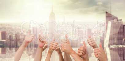 Composite image of group of hands giving thumbs up
