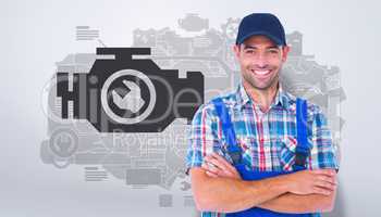 Composite image of happy repairman standing arms crossed on whit