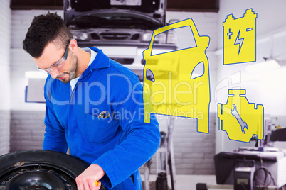 Composite image of mechanic working on tire