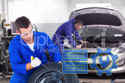 Composite image of mechanic working on tire over white backgroun