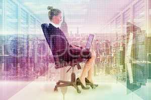 Composite image of businesswoman sitting on swivel chair with la