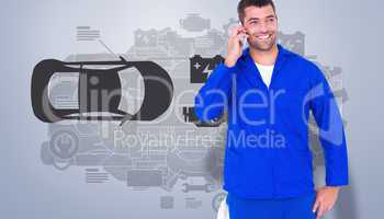 Composite image of smiling male mechanic using mobile phone