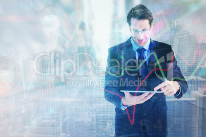 Composite image of businessman standing while using a tablet pc