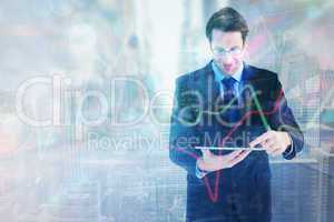 Composite image of businessman standing while using a tablet pc
