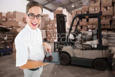 Composite image of geeky businessman using his tablet pc