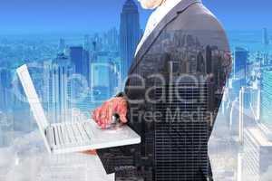 Composite image of businessman holding laptop