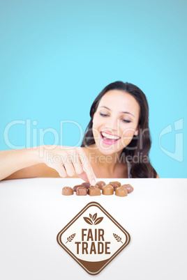 Composite image of pretty brunette picking out chocolate