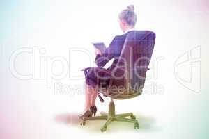 Composite image of businesswoman sitting on swivel chair with ta