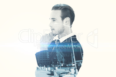 Composite image of thinking businessman standing with hand on ch