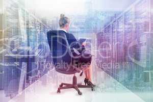 Composite image of businesswoman sitting on swivel chair with ta