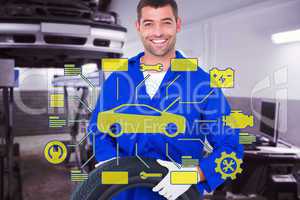 Composite image of mechanic holding tire on white background