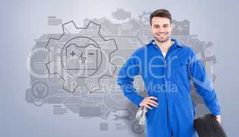 Composite image of smiling male mechanic holding tire