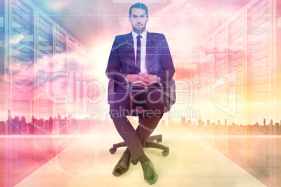 Composite image of stern businessman sitting on an office chair