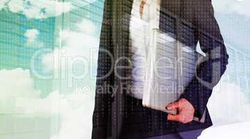 Composite image of businesswoman holding laptop