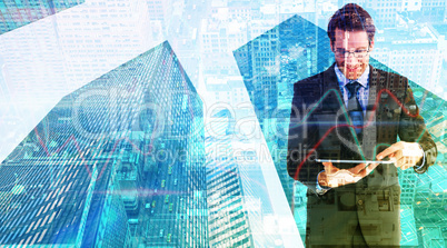 Composite image of businessman standing while using a tablet pc