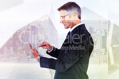 Composite image of mid section of a businessman touching tablet