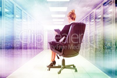 Composite image of businesswoman sitting on swivel chair with ta