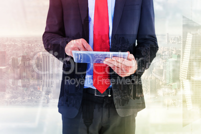 Composite image of businessman scrolling on his digital tablet Composite image of businessman scrolling on his digital tablet