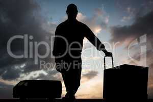 Composite image of confident delivery man with cardboard boxes