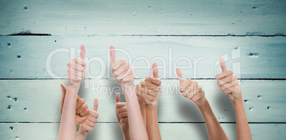 Composite image of thumbs raised and hands up