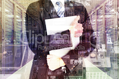 Composite image of businessman holding his laptop tightly