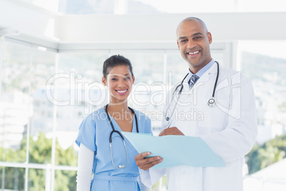 Smiling doctors looking at camera