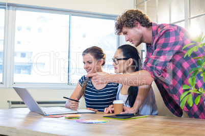 Smiling partners working together on laptop and digitizer