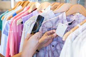 Woman scanning bar code with her mobile phone