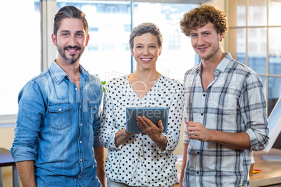 Smiling business team looking together at camera