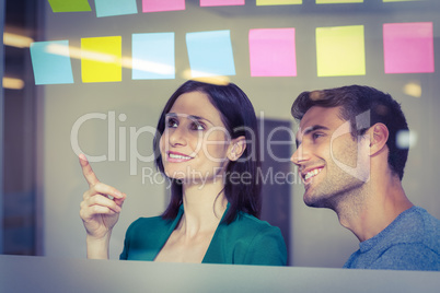 Colleagues looking at sticky notes