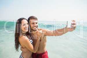 happy couple taking selfie