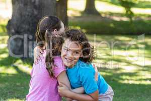 Little siblings smiling at camera