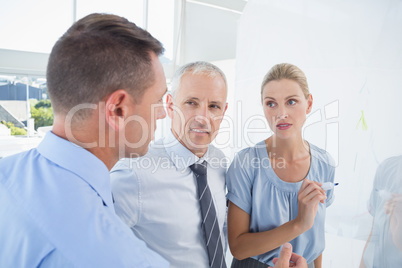 Businesswoman drawing graph on the board