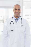 Confident male doctor smiling at camera