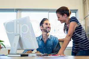 Smiling colleagues talking together