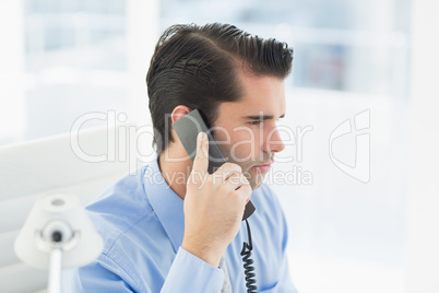 Thoughtful businessman having phone call