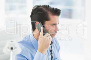 Thoughtful businessman having phone call