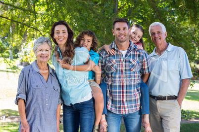 Extended family smiling in the park