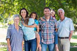 Extended family smiling in the park