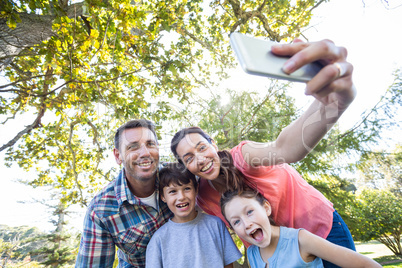 Happy family in the park taking selfie
